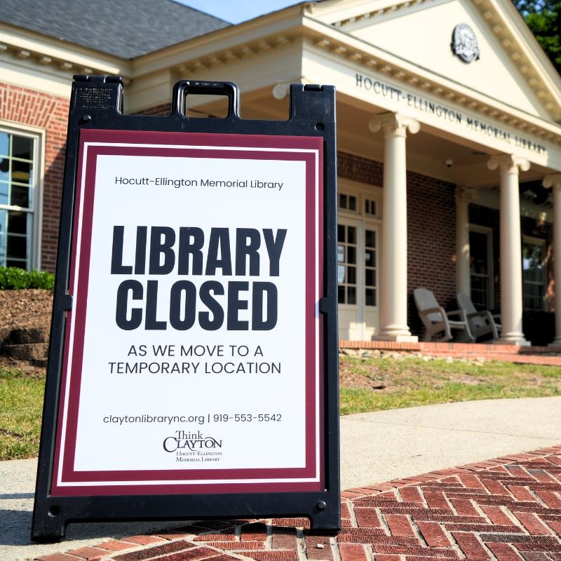 Sign in front of Library labeled Library Closed as we move to a temporary location