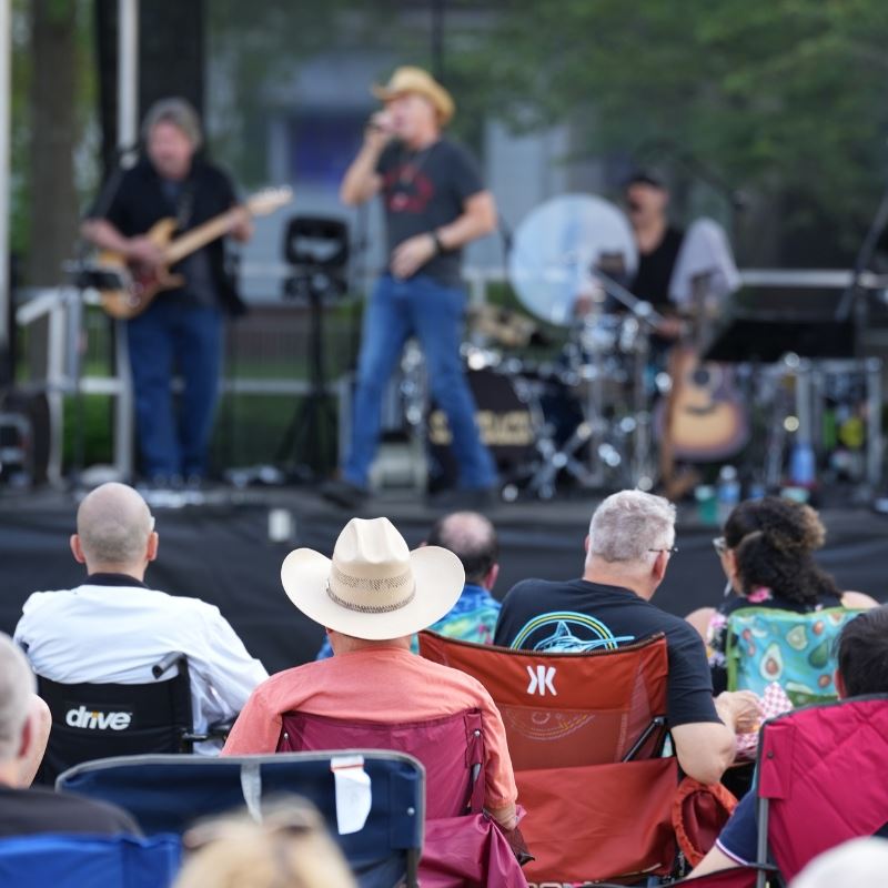 audience watches band perform in Clayton town square 