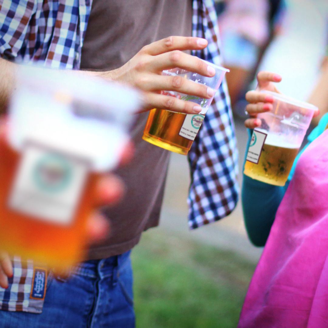 A group of people socializing with cups of alcohol