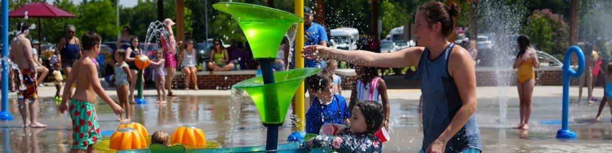 Children Play in splash area outside in park